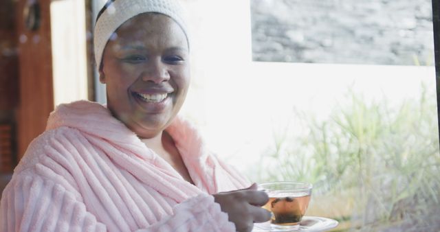 Woman Enjoying Hot Tea in Cozy Bathrobe by the Window - Download Free Stock Images Pikwizard.com