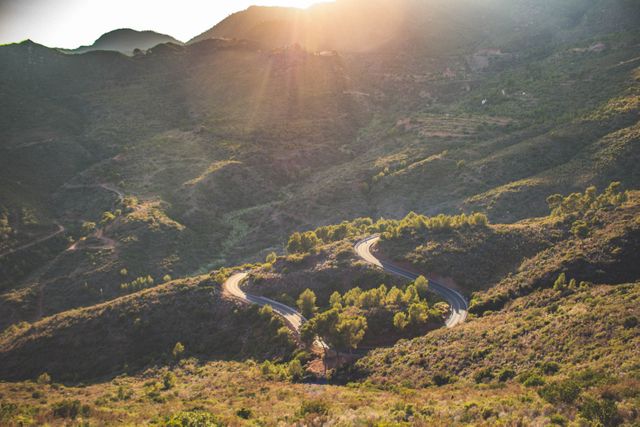 Winding Road in Mountainous Terrain at Sunrise - Download Free Stock Photos Pikwizard.com