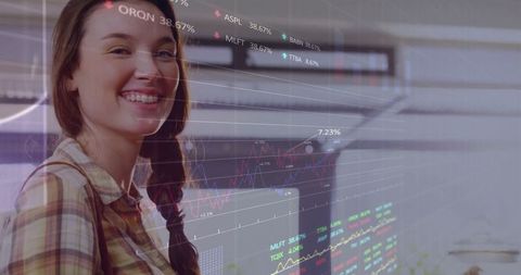 Smiling woman analyzing digital stock data screen in office