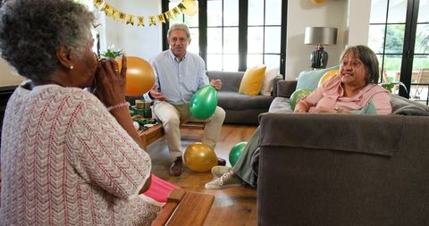Senior Friends Preparing for Festive Birthday Celebration