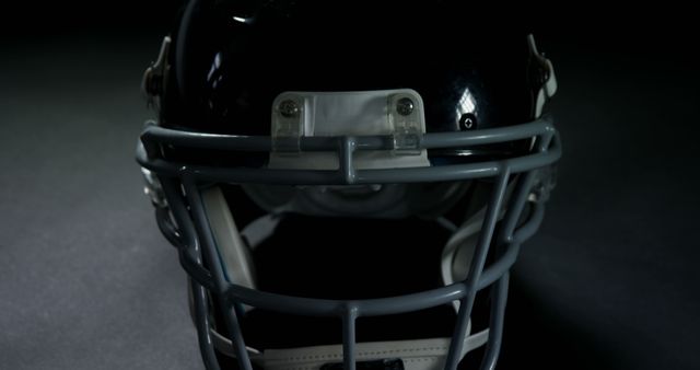 Close-Up of American Football Helmet in Dark Background - Download Free Stock Images Pikwizard.com