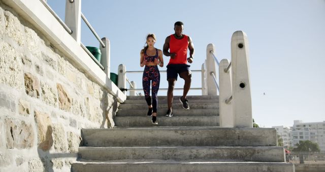 Morning jogging outdoors, diverse couple running down staircase - Download Free Stock Images Pikwizard.com