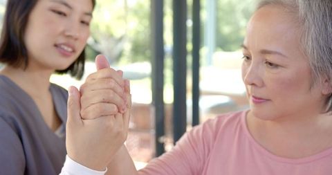 Senior Woman Hand Exercises with Physical Therapist
