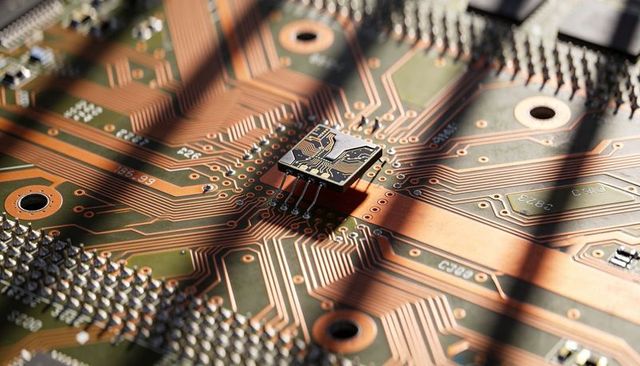 Close-up micro ic mounting on copper pcb with intricate traces, vias and dramatic shadows