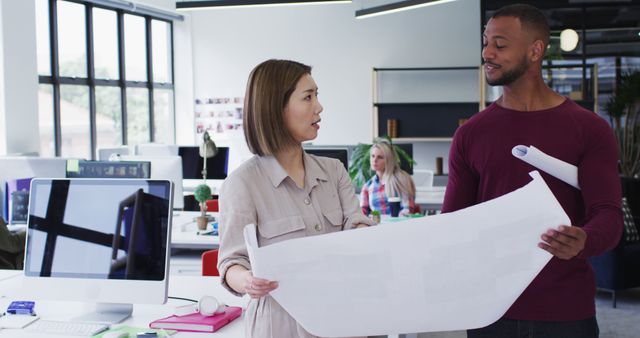 Colleagues Discussing Architectural Plans in Modern Office - Download Free Stock Images Pikwizard.com