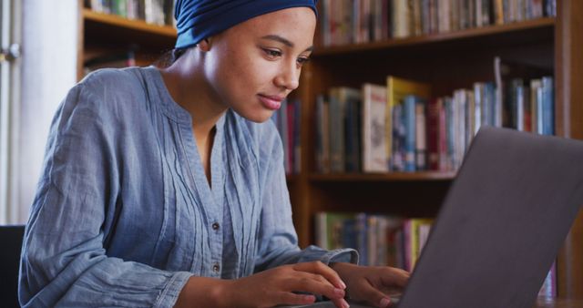 Focused Woman Studying on Laptop in Library - Download Free Stock Images Pikwizard.com