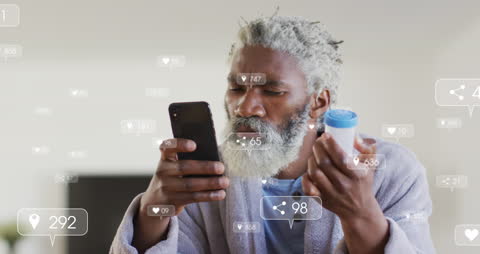 Senior Man Engaging with Social Media on Smartphone at Home