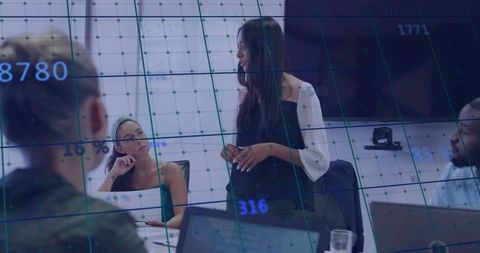 Woman presenting data in modern conference room, team collaborating with analytics overlay