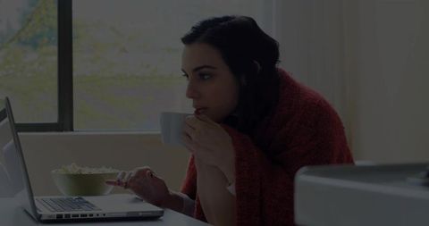Woman Relaxing at Home with Laptop and Warm Drink Comfy Moment