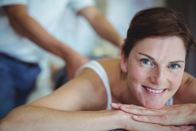 Woman Smiling While Receiving Back Massage in Clinic - Download Free Stock Photos Pikwizard.com