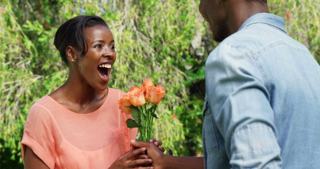 Joyful African American Couple Exchanging Roses in Garden - Download Free Stock Images Pikwizard.com