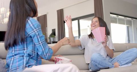 Teen Girls Having Fun Sharing Popcorn on Cozy Couch - Download Free Stock Images Pikwizard.com