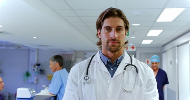 Confident Male Doctor in Modern Hospital Corridor - Download Free Stock Images Pikwizard.com