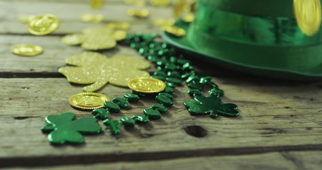 Image of coins and clovers on wooden table. irish tradition and st patrick's day celebration concept digitally generated image.