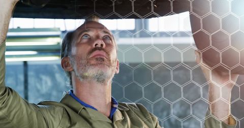 Mechanic Examines Vehicle with Futuristic Interface Design