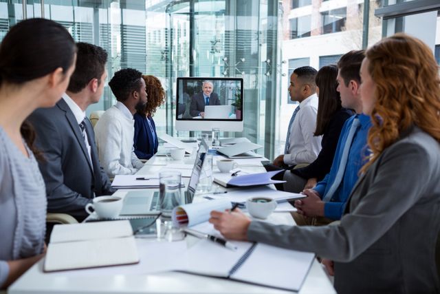 Business people looking at a screen during a video conference - Download Free Stock Photos Pikwizard.com