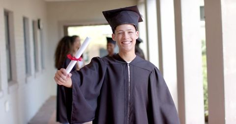 Joyful Teenage Graduate Holding Diploma with Excitement - Download Free Stock Images Pikwizard.com