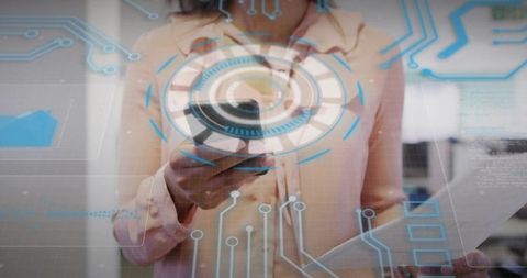 Midadult businesswoman holding smartphone and documents with circular digital hud overlay