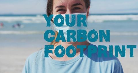 Eco volunteer with face mask on beach promoting carbon footprint awareness
