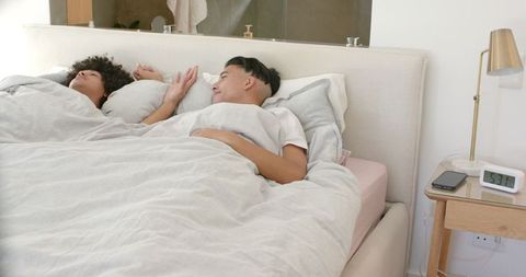 Relaxed Couple Chatting in Bed Morning Scene Romance in Cozy Bedroom