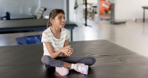 Girl with cerebral palsy participating in physiotherapy rehabilitation