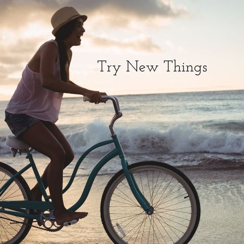 Woman enjoying scenic beach bike ride at sunset
