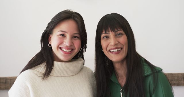 Portrait of happy biracial mother and adult daughter smiling together at home, slow motion - Download Free Stock Photos Pikwizard.com