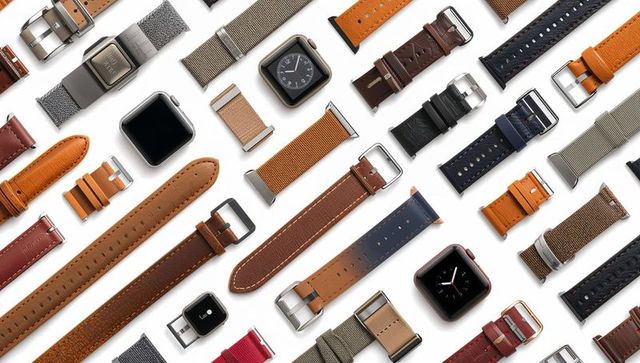 Diagonal flat lay of interchangeable watch straps and smartwatch heads highlighting buckles