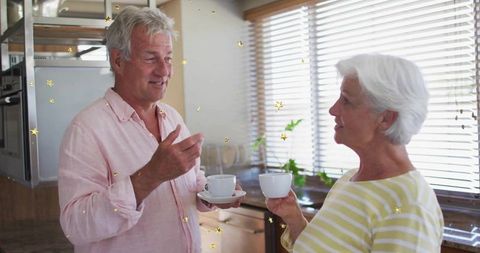 Senior Couple Enjoying Conversation Over Coffee in Cozy Kitchen