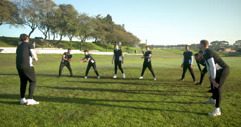 Cricket Team Practicing Fielding Drills Under Sunny Sky