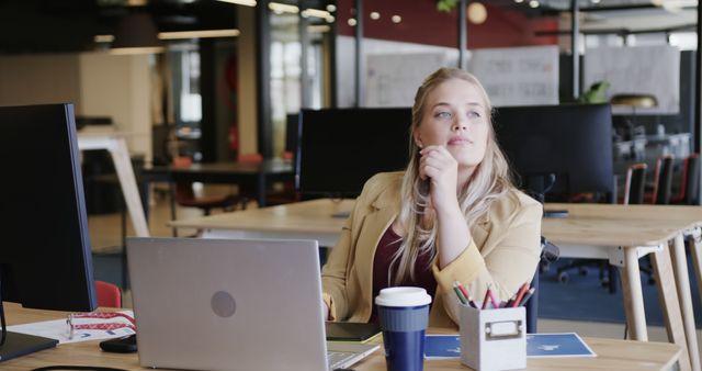 Pensive Businesswoman Sitting at Desk in Modern Office - Download Free Stock Images Pikwizard.com