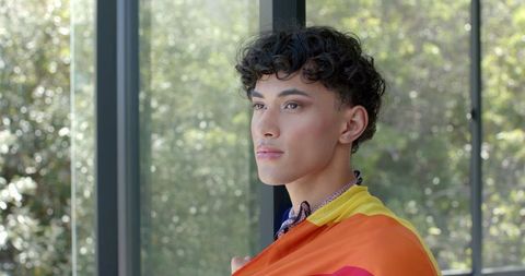 Contemplative Man Displaying Pride Subtly Inside Modern Architecture