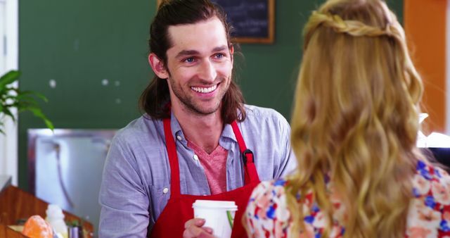 Friendly Barista with Long Hair Serving a Customer a Coffee - Download Free Stock Images Pikwizard.com