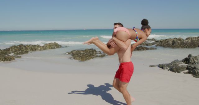 Playful Couple Enjoying Time on Sandy Beach - Download Free Stock Images Pikwizard.com