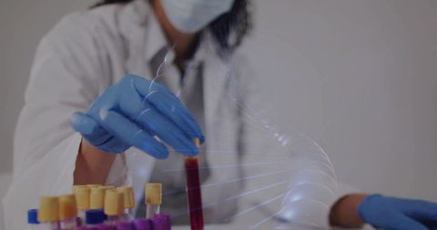 Laboratory technician handling blood tube with dna hologram for genomic testing
