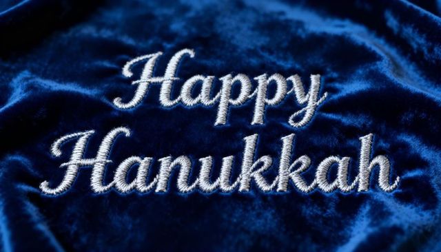 Happy Hanukkah embroidery on luxurious blue velvet with silver rope-style stitched script