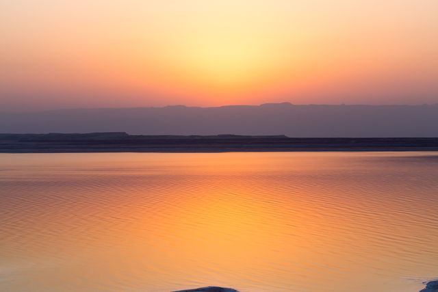 Stunning Sunset Over Tranquil Water Body with Soft Reflection - Download Free Stock Photos Pikwizard.com