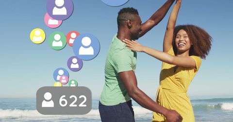 Joyful Couple Dancing on Beach with Social Media Icons