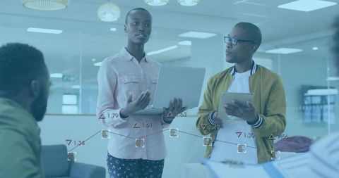 Modern Office Team Analyzing Data with Digital Overlays