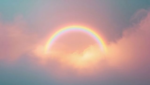 Pastel Rainbow Arch Glowing Above Luminous Clouds at Dawn for Dreamy Serene Sky Background