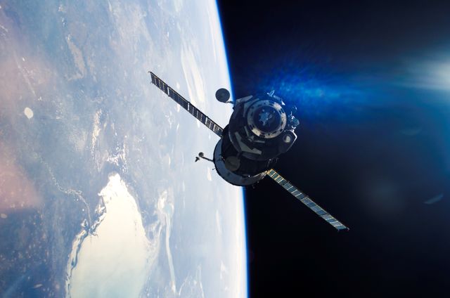 Soyuz TMA-7 spacecraft approaching the International Space Station with Earth visible in the background. This can be used in articles and presentations about space exploration, the @#$11, and NASA missions. Suitable for educational materials tracing human spaceflight advancements and international cooperation in space.