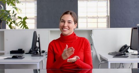Confident Businesswoman Smiling at Modern Office Desk