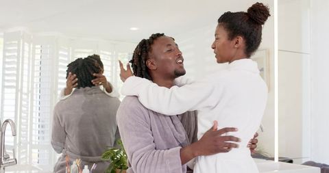 African american couple embracing at bathroom vanity during cozy morning routine