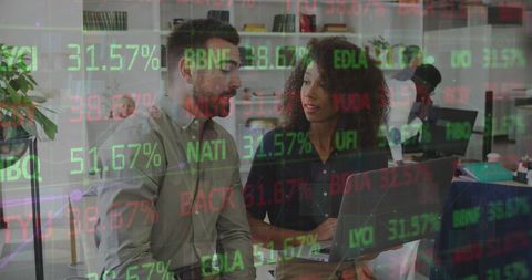 Stock Market Trends Analyzed by Business Professionals in Office