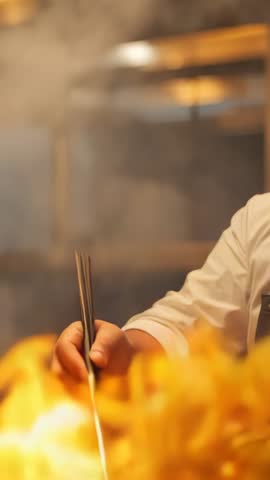 Chef Tossing Vegetables in Flaming Wok Vertical Video Showing High-Heat Stir-Fry Technique