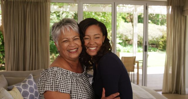 Portrait of happy biracial senior mother and adult daughter embracing at home and smiling - Download Free Stock Photos Pikwizard.com