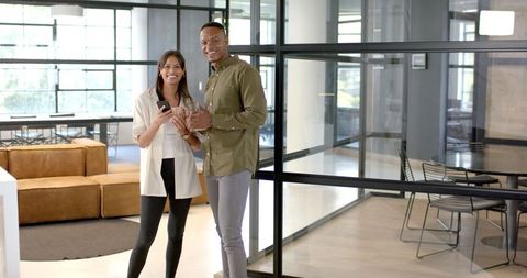 Business Colleagues Holding Smartphones in Modern Corporate Office