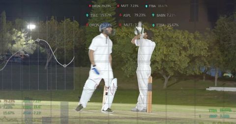 Night cricket players adjusting helmet at crease with digital batting analytics overlay