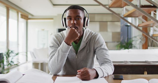 African american male teenager wearing headphones having a image conversation - Download Free Stock Photos Pikwizard.com