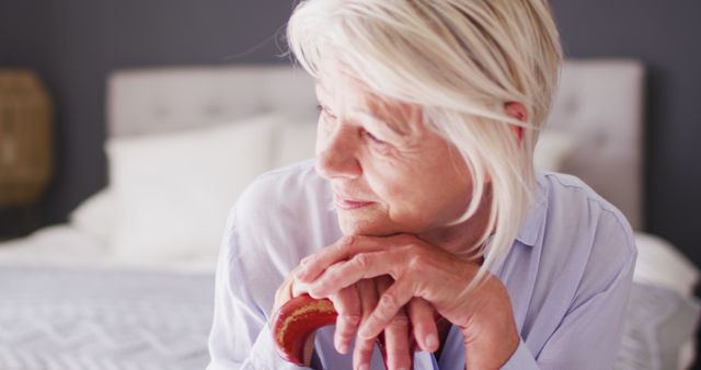 Pensive Elderly Woman Sitting on Bed, Lost in Thought - Download Free Stock Images Pikwizard.com